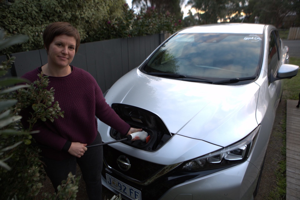 Woman charging electric car