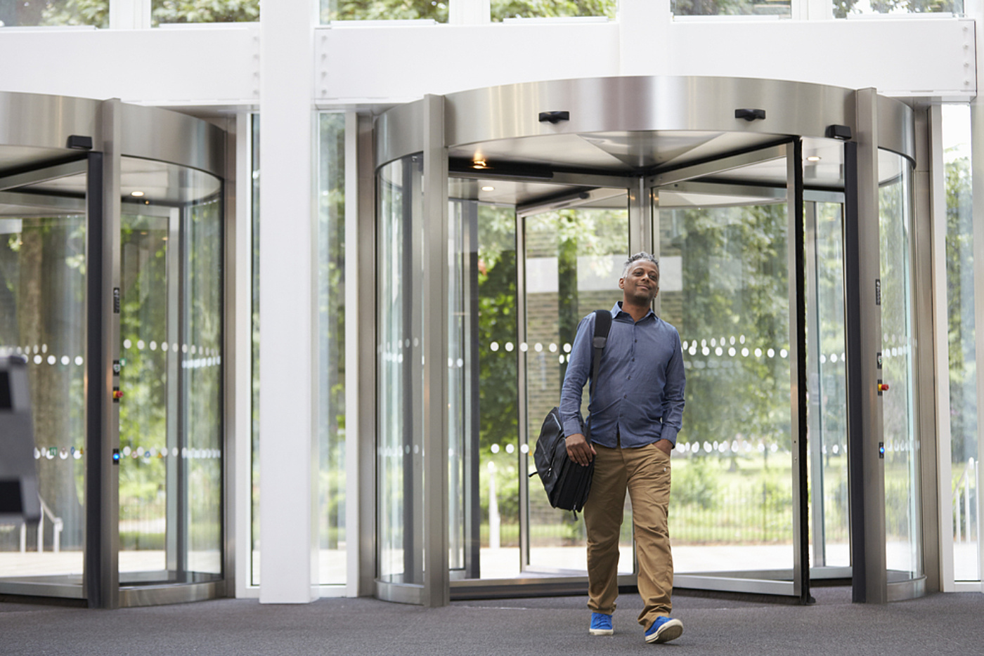 Office worker revolving door shutterstock 478439839